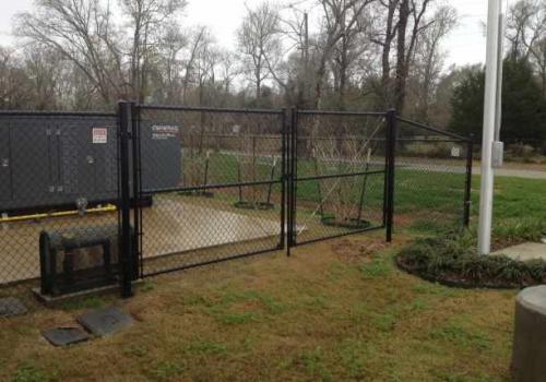 industrial chainlink fence with gate protecting transformer