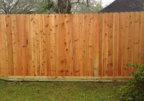 simple residential fencing protecting backyard with tree