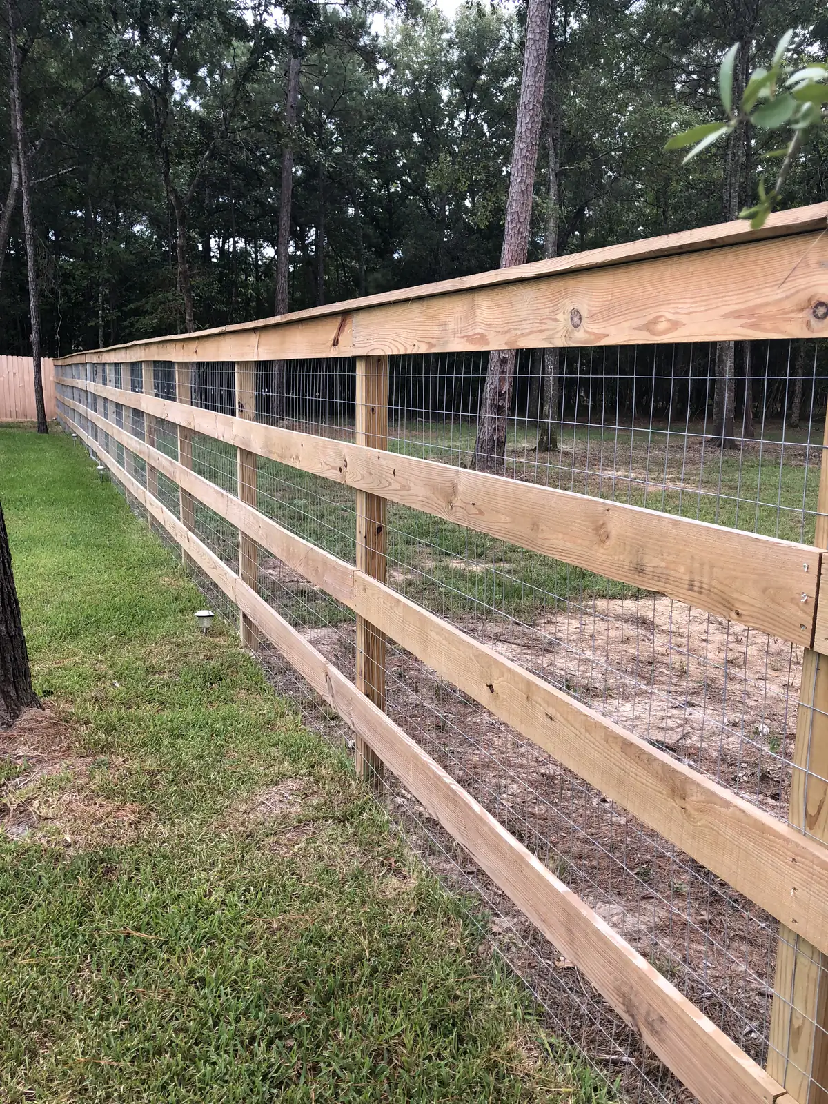 Four rail ranch style fence with wire mesh backing
